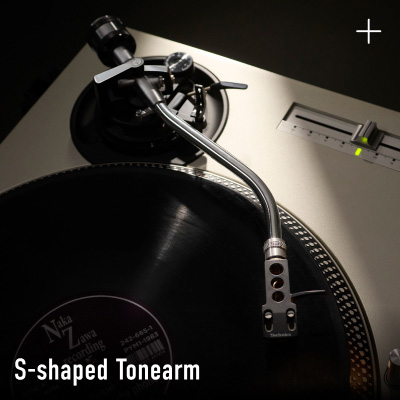 Close-up photograph of the S-shaped tonearm on a Technics turntable with a vinyl record visible, with the label "S-shaped Tonearm" in white text at the bottom left.