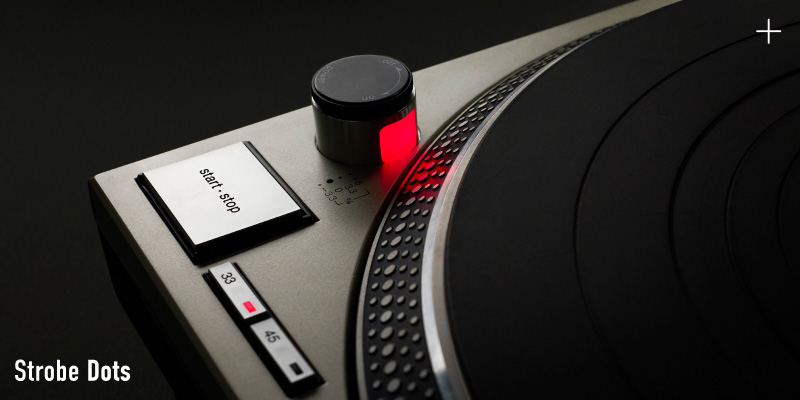 Close-up photograph of the start/stop button and red-illuminated strobe dots on a Technics turntable, with the label "Strobe Dots" in white text at the bottom left.