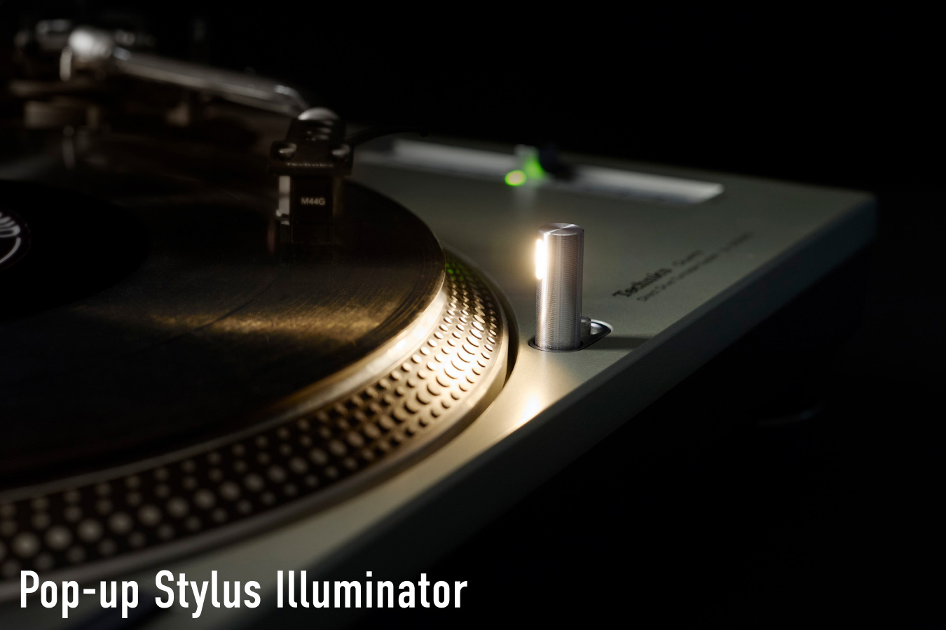 Close-up photograph of the pop-up stylus illuminator on a Technics turntable, glowing against a dark background, with the label "Pop-up Stylus Illuminator" in white text at the bottom left.