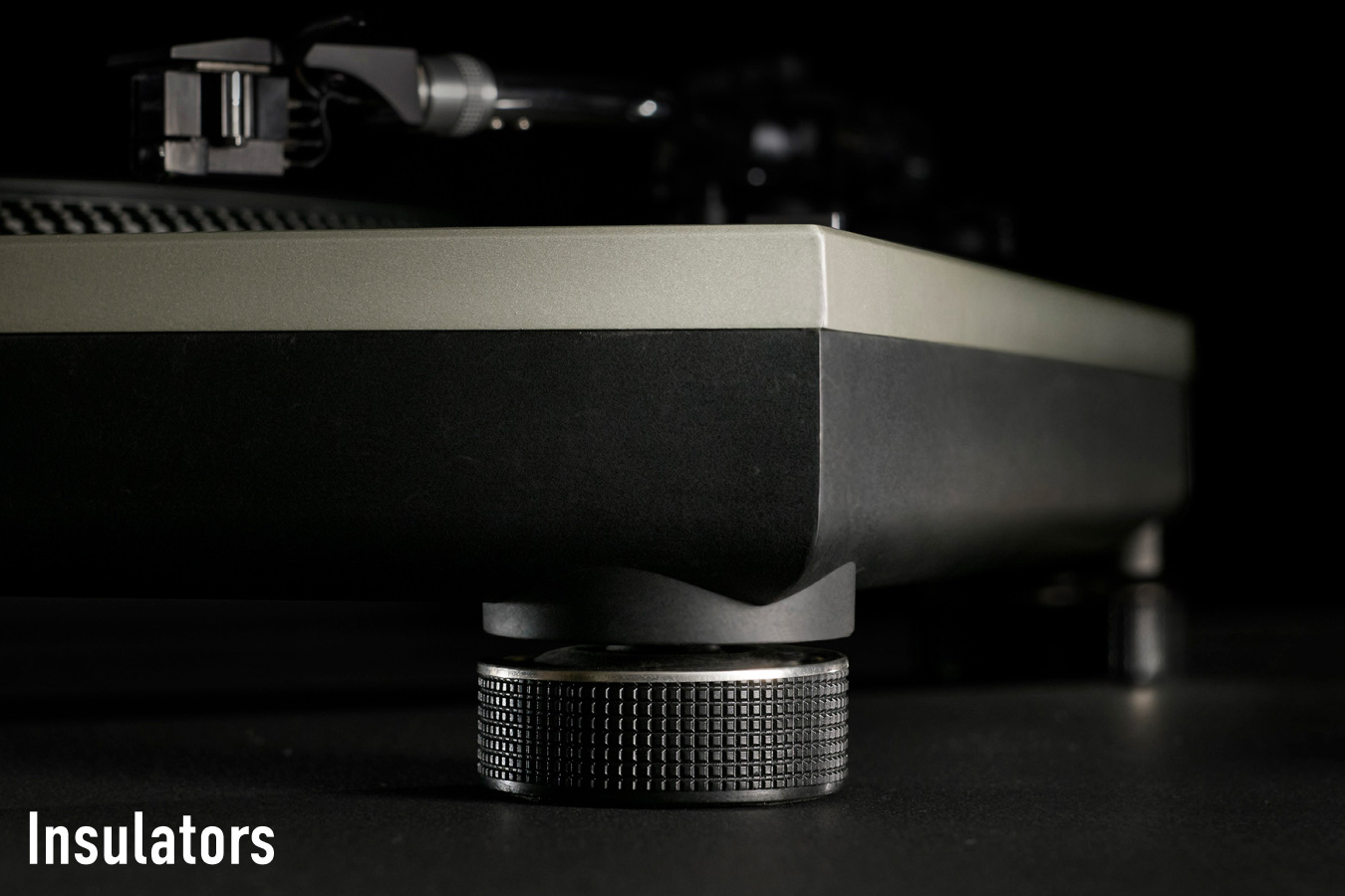 Close-up photograph of the adjustable insulator foot beneath a Technics turntable chassis, with the label "Insulators" in white text at the bottom left.