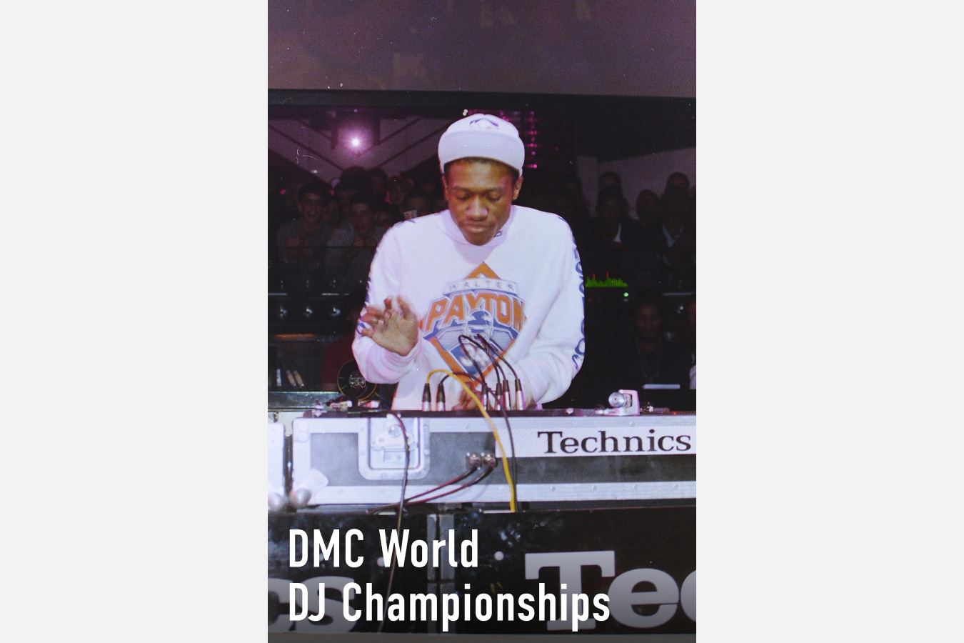 A photograph of a DJ performing on Technics turntables at the DMC World DJ Championships, wearing a Walter Payton jersey, with the Technics logo visible on the equipment.